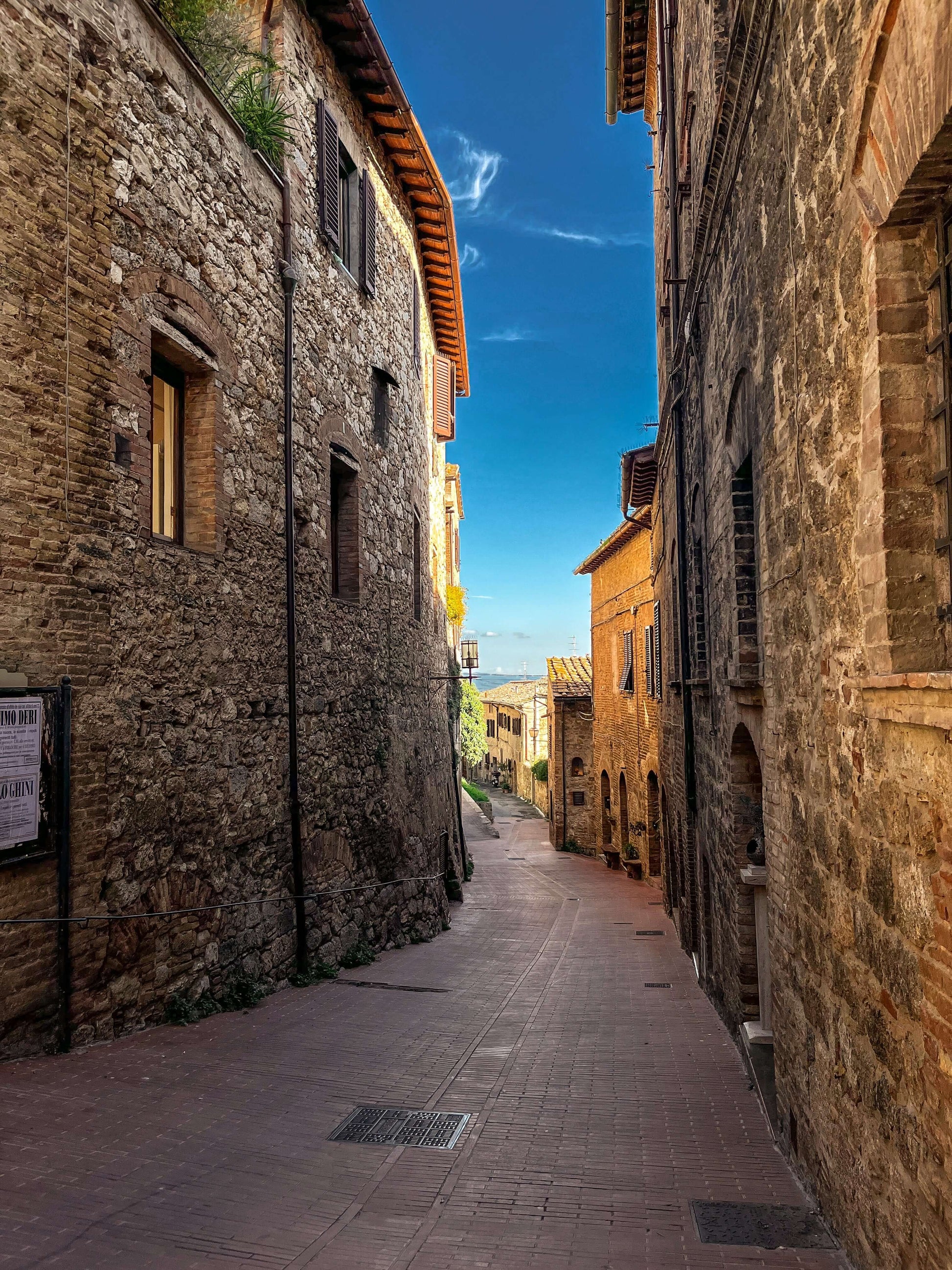 Street view of San Gimignano Medieval Fortress in Italy, capturing historic architecture and charm, perfect for art lovers and travel enthusiasts
